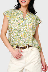 Woman modeling Cap Sleeve Notch Neck Blouse in Secret Garden Floral styled for the office