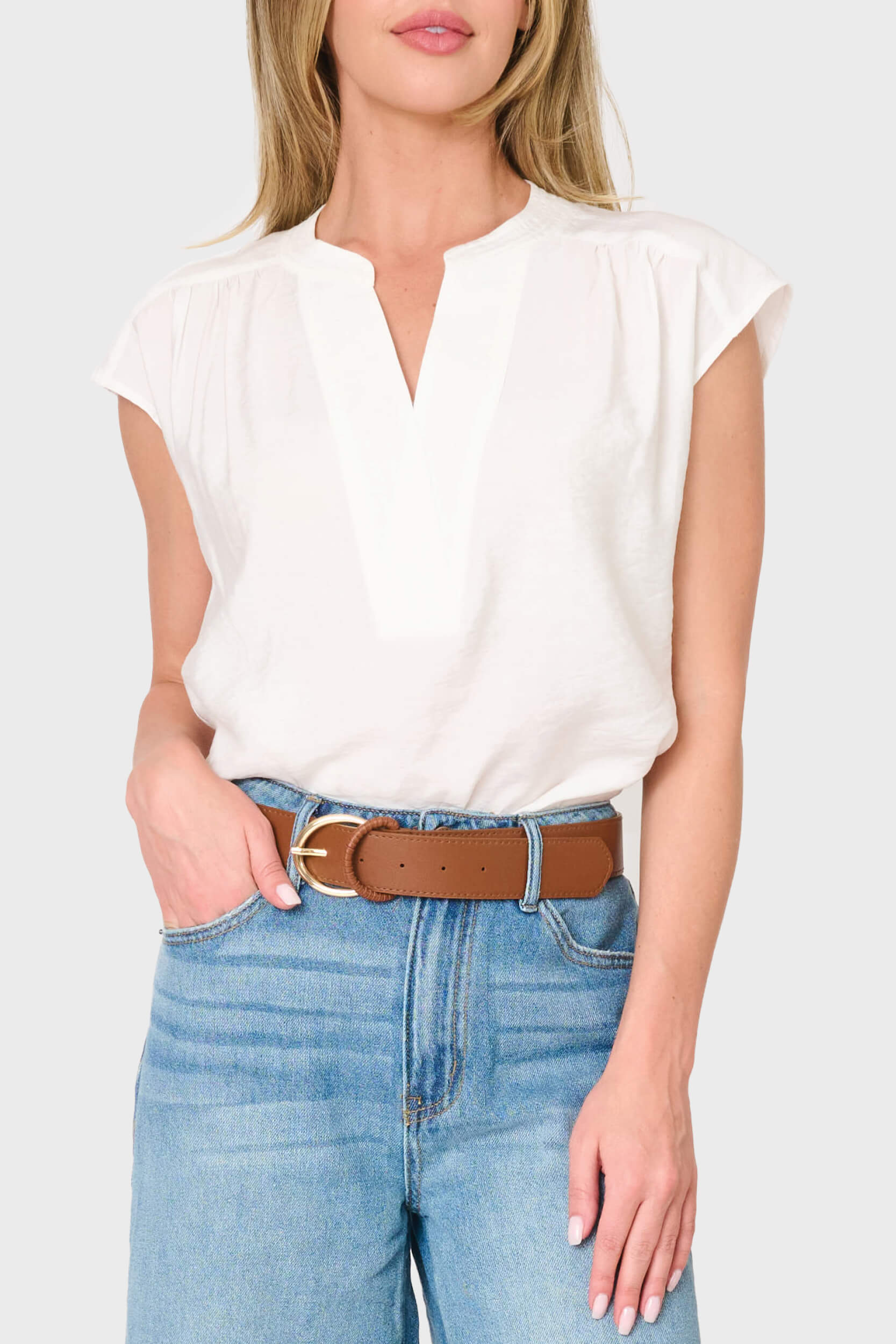 Woman modeling Cap Sleeve Notch Neck Blouse in White styled for everyday and the office