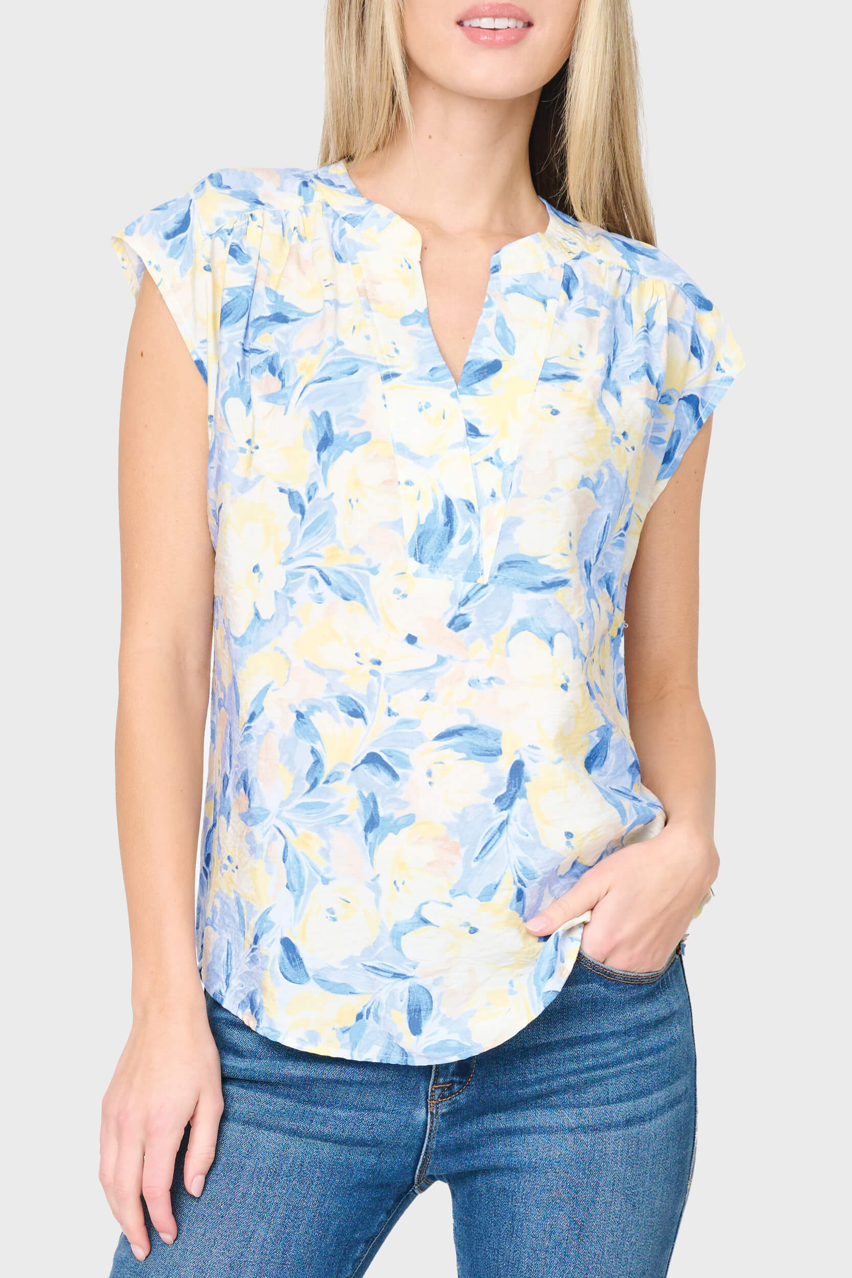 Woman modeling Cap Sleeve Notch Neck Blouse in Yellow navy floral styled for work, brunch, and everyday