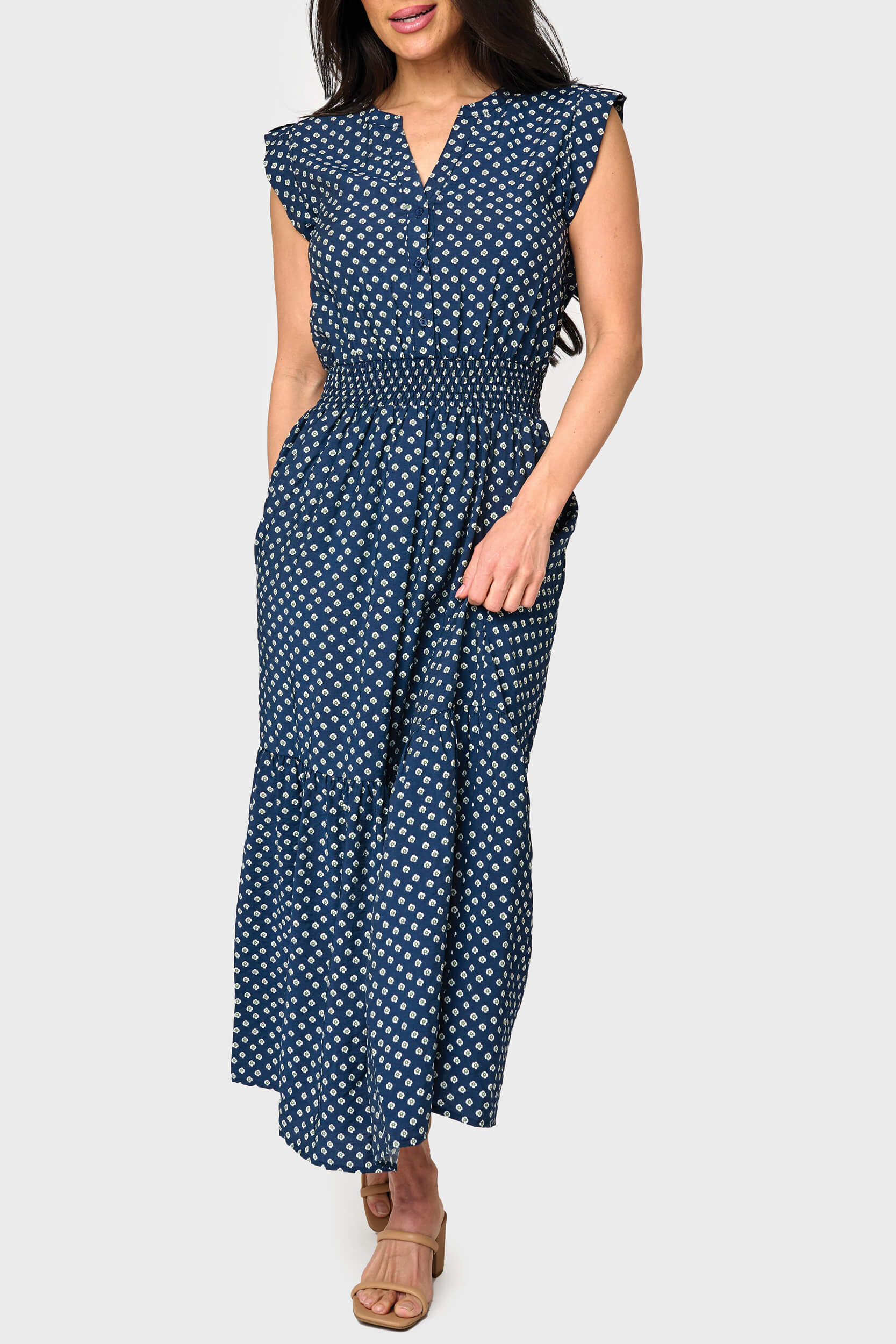 Woman modeling Lindsey Utility Maxi Dress in Navy Daisy print styled business casual with sandals for work