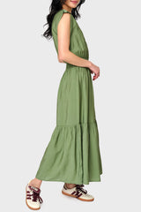 Side view of Woman modeling Lindsey Utility Maxi Dress in Vineyard Green styled with sneakers