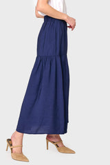 Side view of Woman modeling Playa Tiered Maxi Skirt in Navy styled with heels