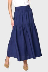 Woman modeling Playa Tiered Maxi Skirt in Navy styled with heels