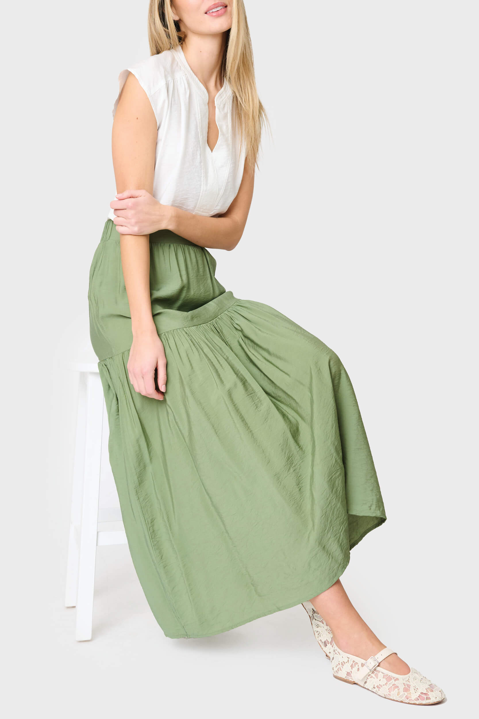 woman modeling Playa Tiered Maxi Skirt in vineyard green styled for work and everyday