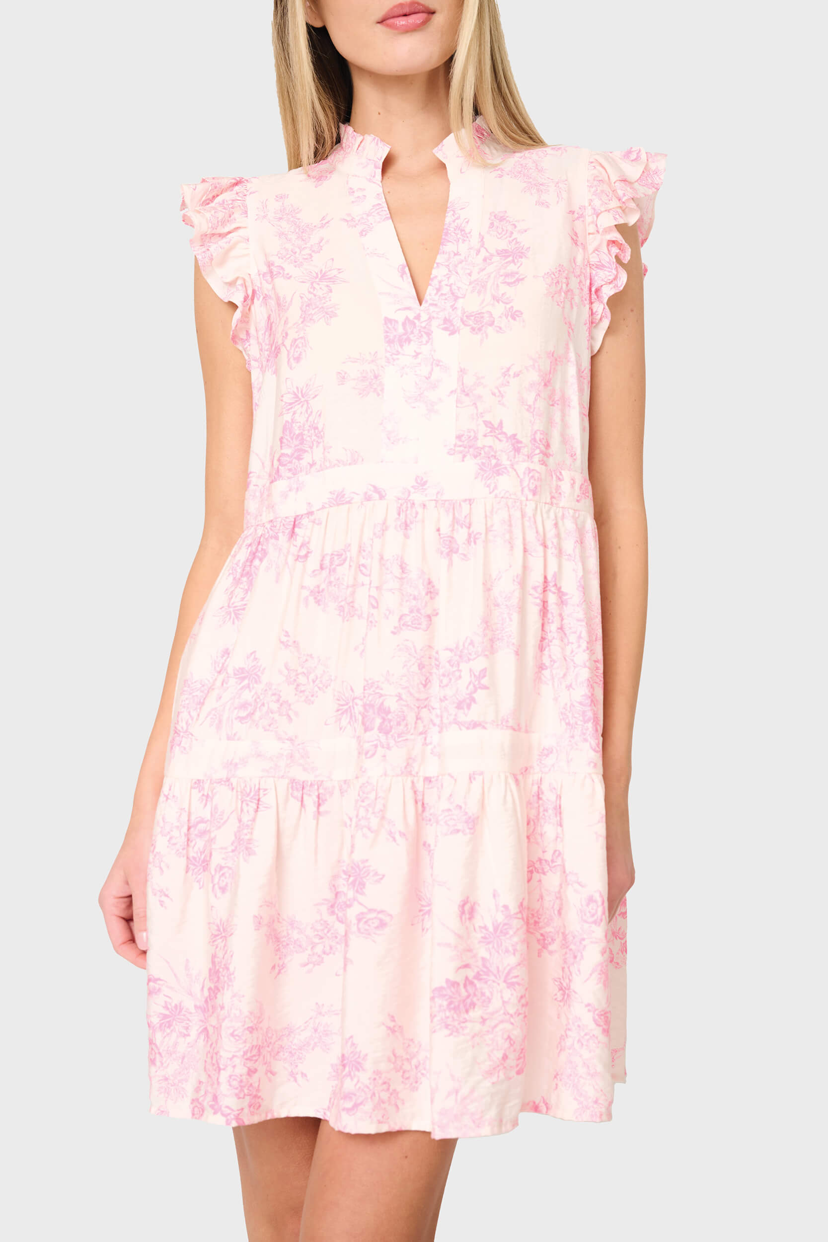 Woman modeling Flutter Sleeve Decked Out Day Dress in Pink floral toile print styled for everyday