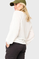 Side of Woman modeling Courtside Open Weave Sweater in White styled for a casual weekend