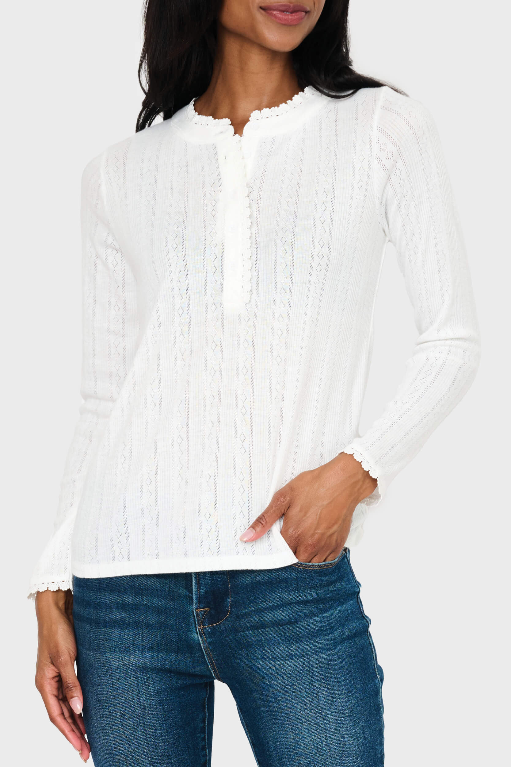 Woman modeling Ava Crochet Trim Pointelle Henley Top in White styled everyday casual