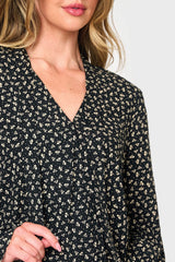 Surplice v-neck and tie neck detail of Woman modeling Long Sleeve Surplice Blouse With Ruffle Sleeve in Black boho floral print