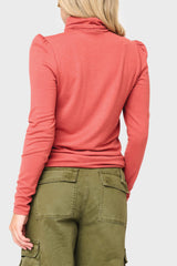 Back of Woman modeling Essential Turtleneck Soft Sweater Knit Top With Puff Sleeve in Burnt Sienna orange styled everyday casual