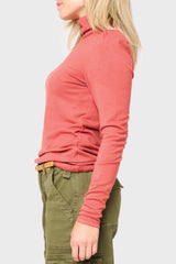 Side of Woman modeling Essential Turtleneck Soft Sweater Knit Top With Puff Sleeve in Burnt Sienna orange styled everyday casual