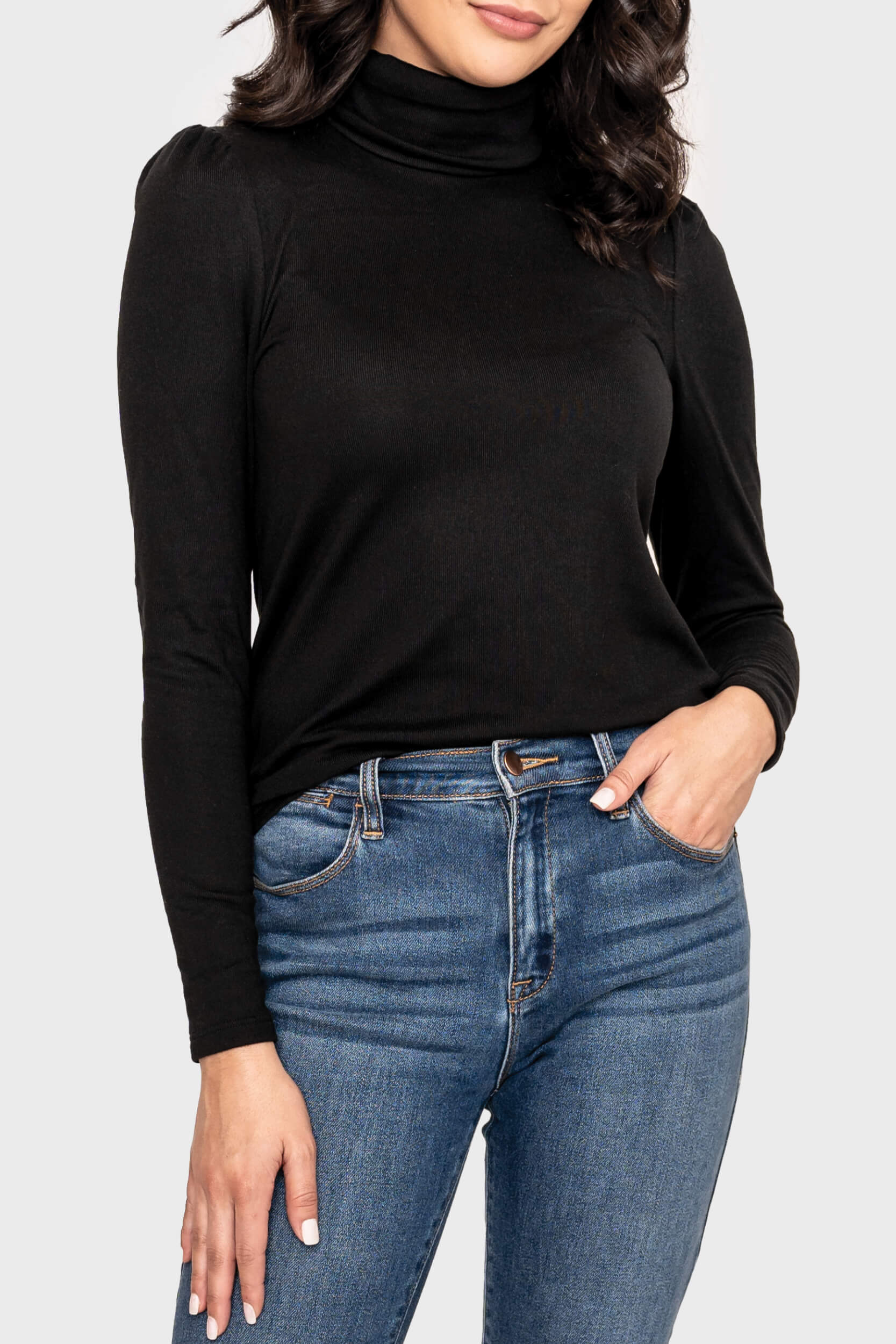 Woman modeling Essential Turtleneck Soft Sweater Knit Top with Puff Sleeve in Black styled for layering