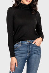 Woman modeling Essential Turtleneck Soft Sweater Knit Top with Puff Sleeve in Black styled for layering