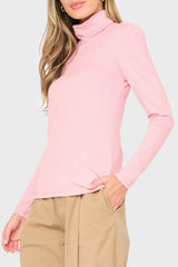 Side of Woman modeling Essential Turtleneck Soft Sweater Knit Top With Puff Sleeve in Pink styled business casual