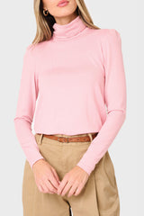 Woman modeling Essential Turtleneck Soft Sweater Knit Top With Puff Sleeve in Pink styled business casual