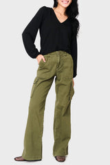 Person wearing olive green cargo pants and a black top on a white background