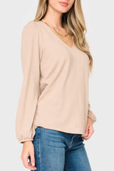 Side of Woman modeling V-Neck Blouson Sleeve Sweater in Taupe tan, styled business casual for work