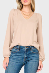 Woman modeling V-Neck Blouson Sleeve Sweater in Taupe tan, styled business casual for work
