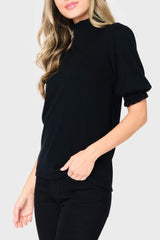Side of Woman modeling Feminine Mock Neck Luxe Sweater Top in Black styled business casual