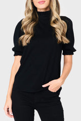 Woman modeling Feminine Mock Neck Luxe Sweater Top in Black styled business casual