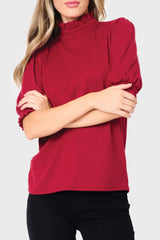 Woman modeling Feminine Mock Neck Luxe Sweater Top in Cranberry red styled business casual