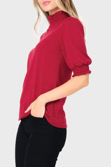 Side of Woman modeling Feminine Mock Neck Luxe Sweater Top in Cranberry red styled business casual