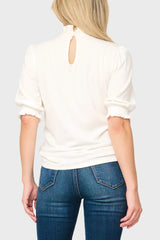 Keyhole back of Woman modeling Feminine Mock Neck Luxe Sweater Top in Ivory styled for work and everyday
