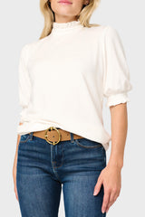 Woman modeling Feminine Mock Neck Luxe Sweater Top in Ivory styled for work and everyday