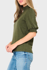 Side of Woman modeling Feminine Mock Neck Luxe Sweater Top in olive green styled business casual for work