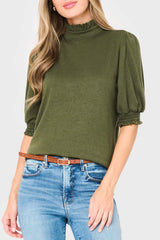 Woman modeling Feminine Mock Neck Luxe Sweater Top in olive green styled business casual for work