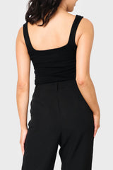 Back of Woman modeling Feminine Luxe Sweater Tank in Black styled as layer for work