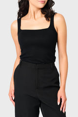 Woman modeling Feminine Luxe Sweater Tank in Black styled as layer for work