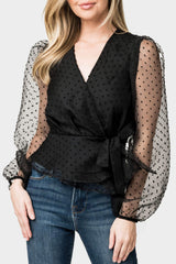 Woman modeling Surplice Wrap Top with Organza Dot Sleeve in Black styled for holiday parties