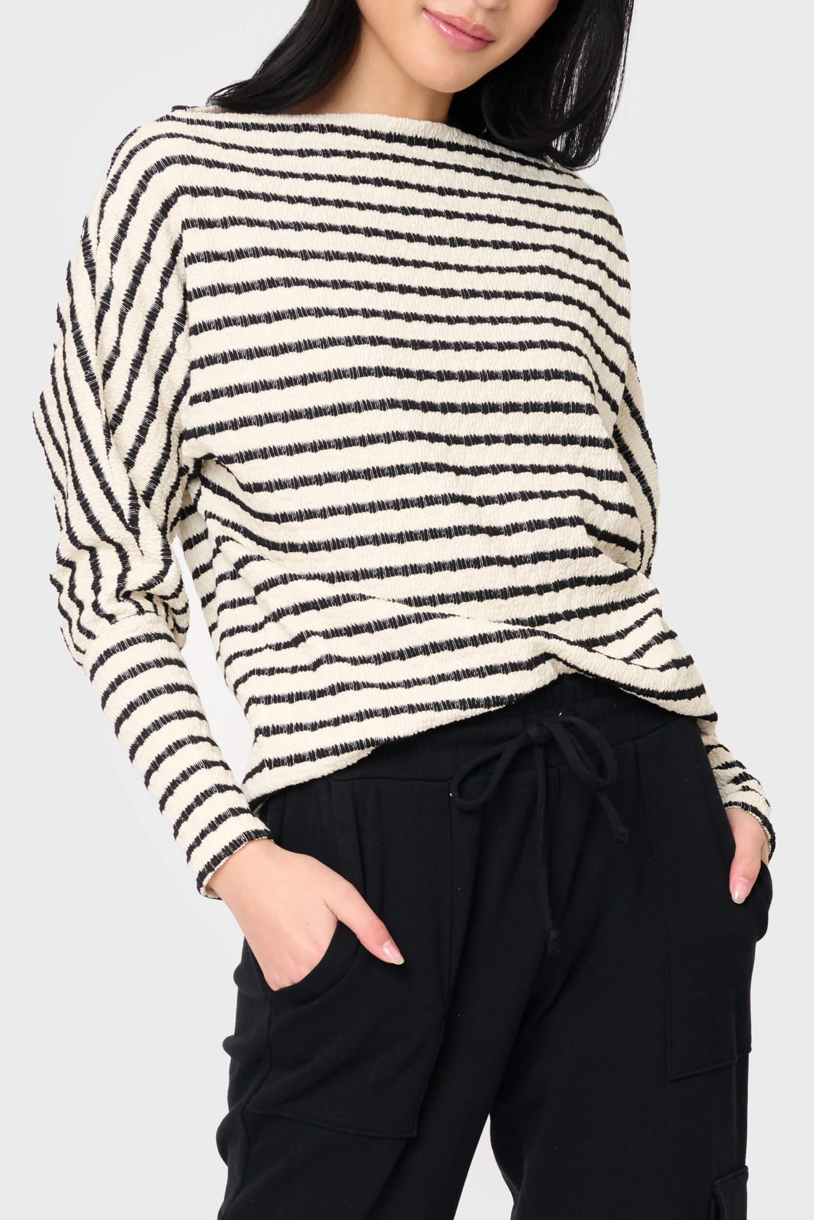 Woman modeling Slouchy Open Neck Striped Knit Top in black ivory stripe styled for everyday workleisure