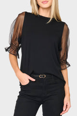 woman modeling Organza Puff Sleeve Soft Ponte Top in black styled business casual for holiday events