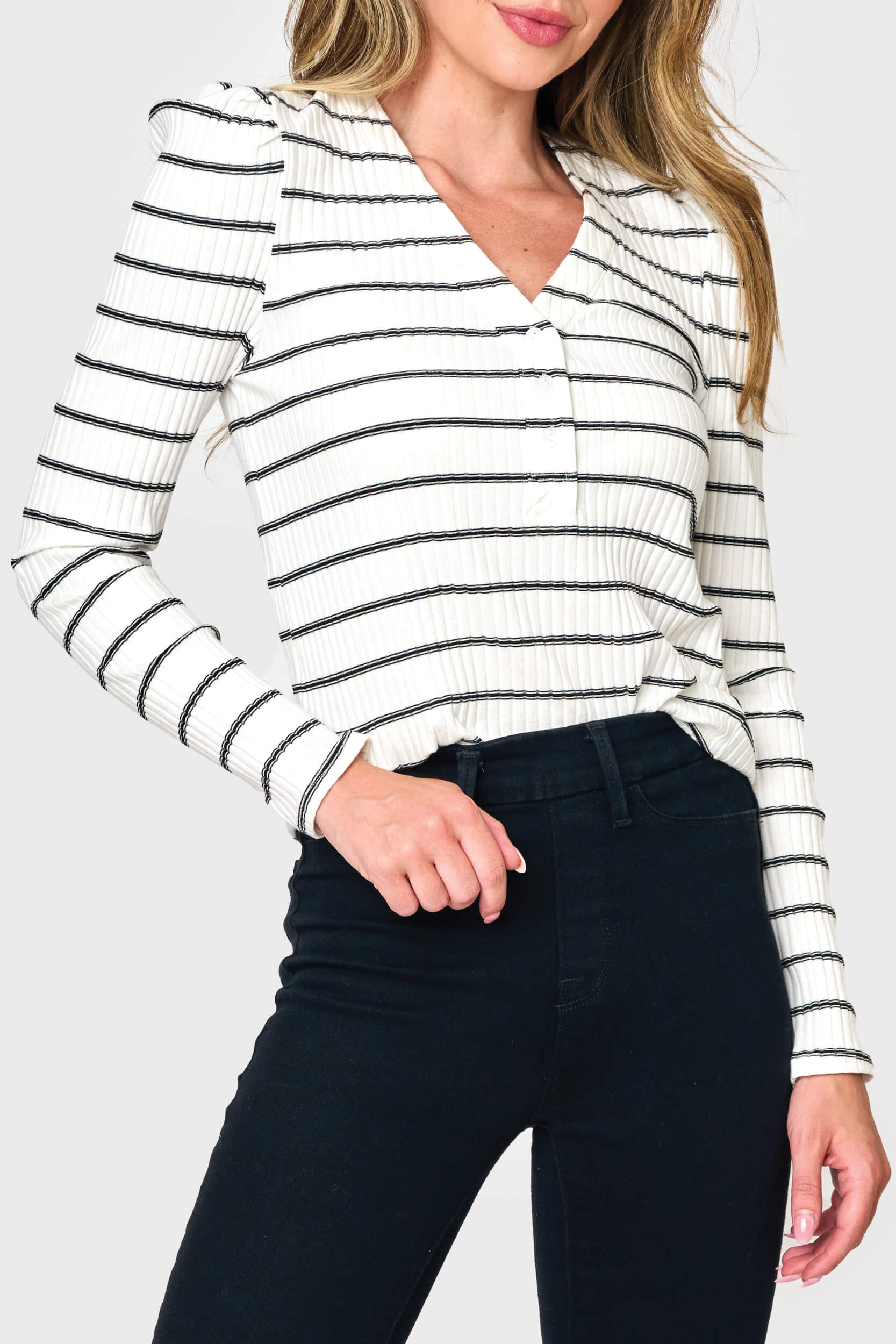 Woman modeling The Amelia Ribbed Henley Top in Black White stripe styled business casual