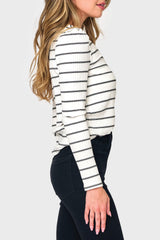 Side of Woman modeling The Amelia Ribbed Henley Top in Black White stripe styled business casual