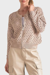 Woman wearing a beige knit cardigan on a white background