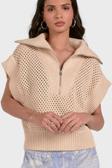 Woman wearing a beige knit vest with a zipper on a white background