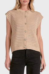 Woman wearing a beige knitted vest on a white background