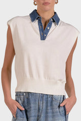 White sleeveless sweater with denim collar worn by a person on a plain background