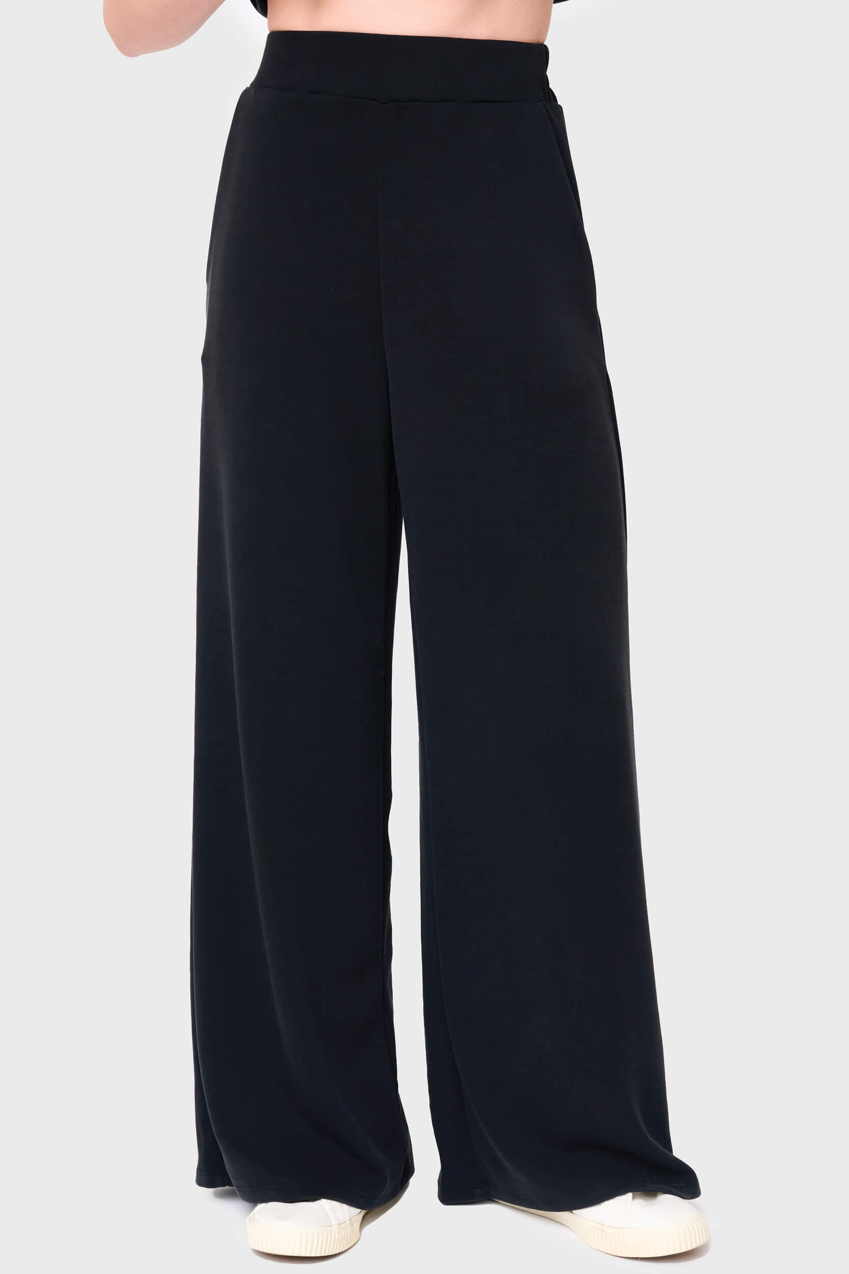 Woman modeling Soft Cloud Scuba Luxe Everywhere Pant in black, styled with sneakers
