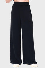 Woman modeling Soft Cloud Scuba Luxe Everywhere Pant in black, styled with sneakers