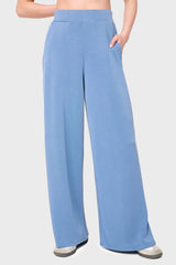 Woman modeling Soft Cloud Scuba Luxe Everywhere Pant in denim blue, styled with sneakers