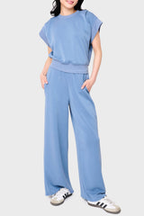 Woman modeling Soft Cloud Scuba Luxe Everywhere Pant in denim blue, styled with match top and sneakers