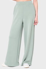 Woman modeling Soft Cloud Scuba Luxe Everywhere Pant in sage green, styled with sneakers