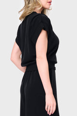 Side view Woman modeling Soft Cloud Scuba Luxe Everywhere Top in black, styled with the matching pants