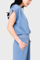 Side view Woman modeling Soft Cloud Scuba Luxe Everywhere Top in denim blue, styled with the matching pants