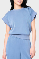 Woman modeling Soft Cloud Scuba Luxe Everywhere Top in denim blue, styled with the matching pants