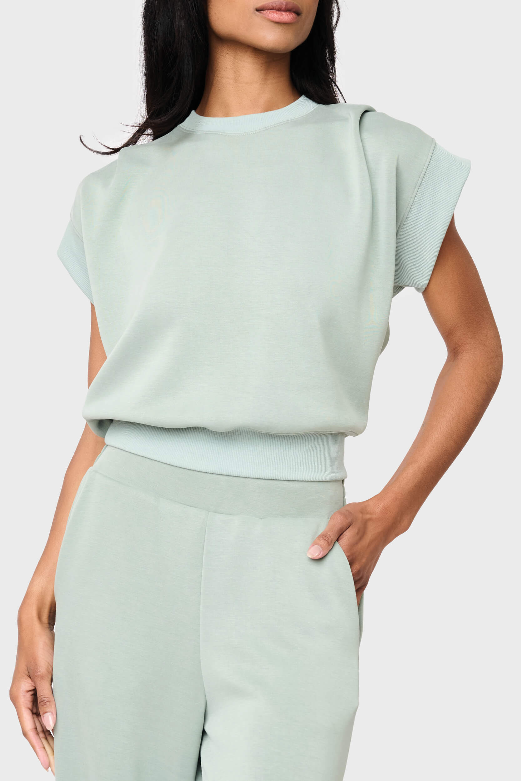Woman modeling Soft Cloud Scuba Luxe Everywhere Top in sage green, styled with the matching pants
