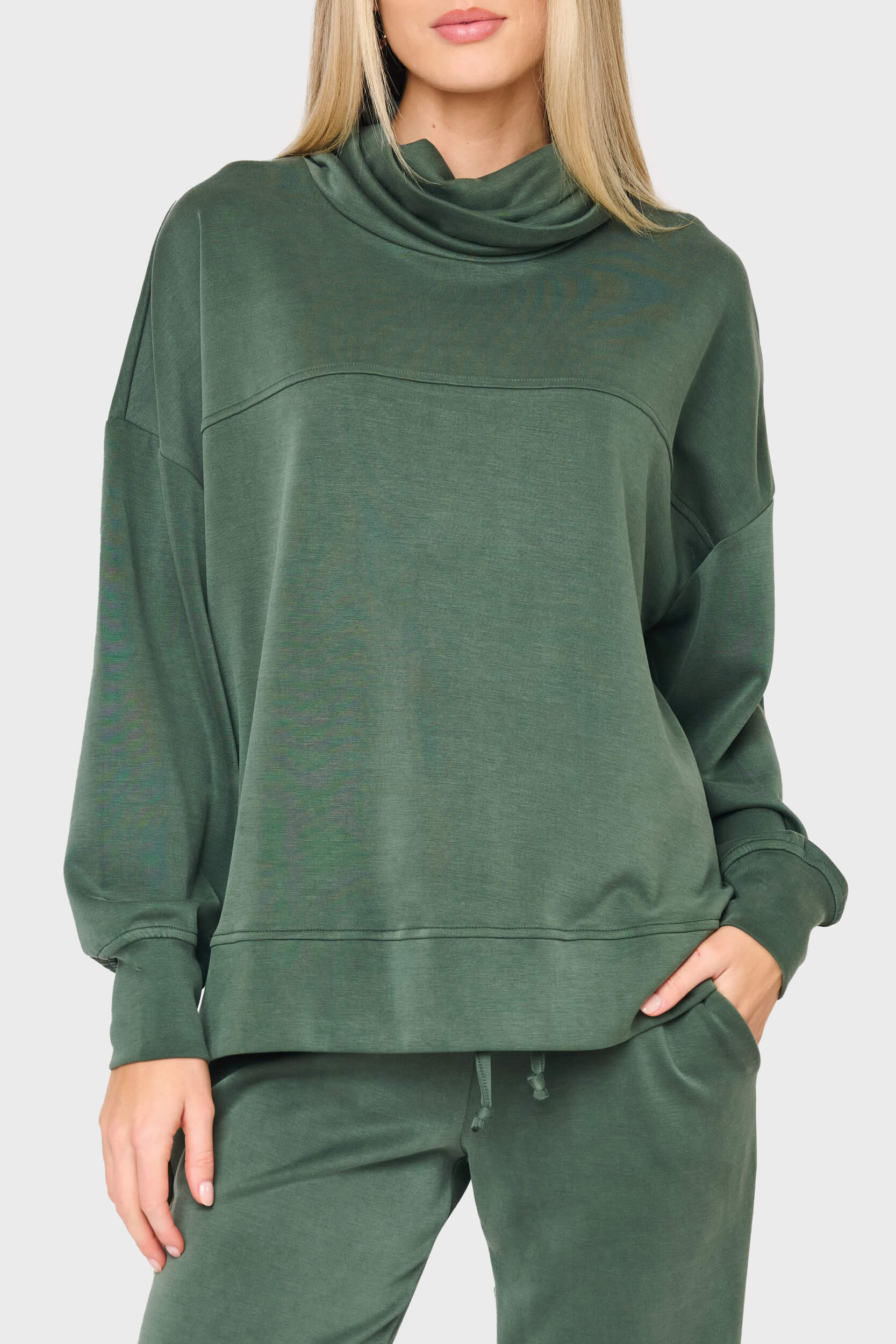 woman modeling Cloud Scuba Mock Neck Everywhere Top in green styled as matching set for lounging and weekends
